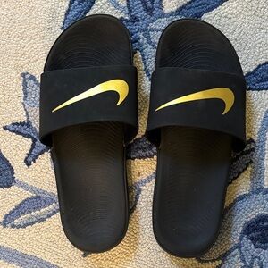 Nike Black Slides with Gold Swoosh Logo